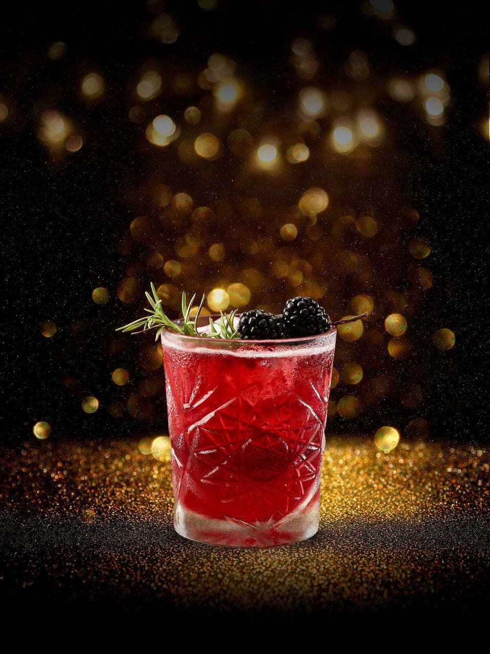 a glass with a drink and berries
